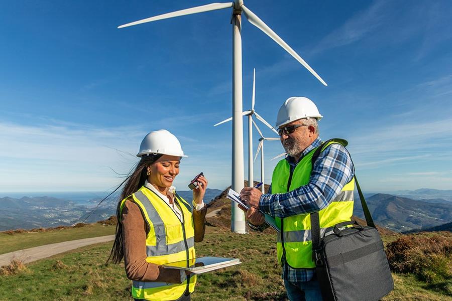 Wind energy professionals working on wind turbines enjoying their renewable energy career.