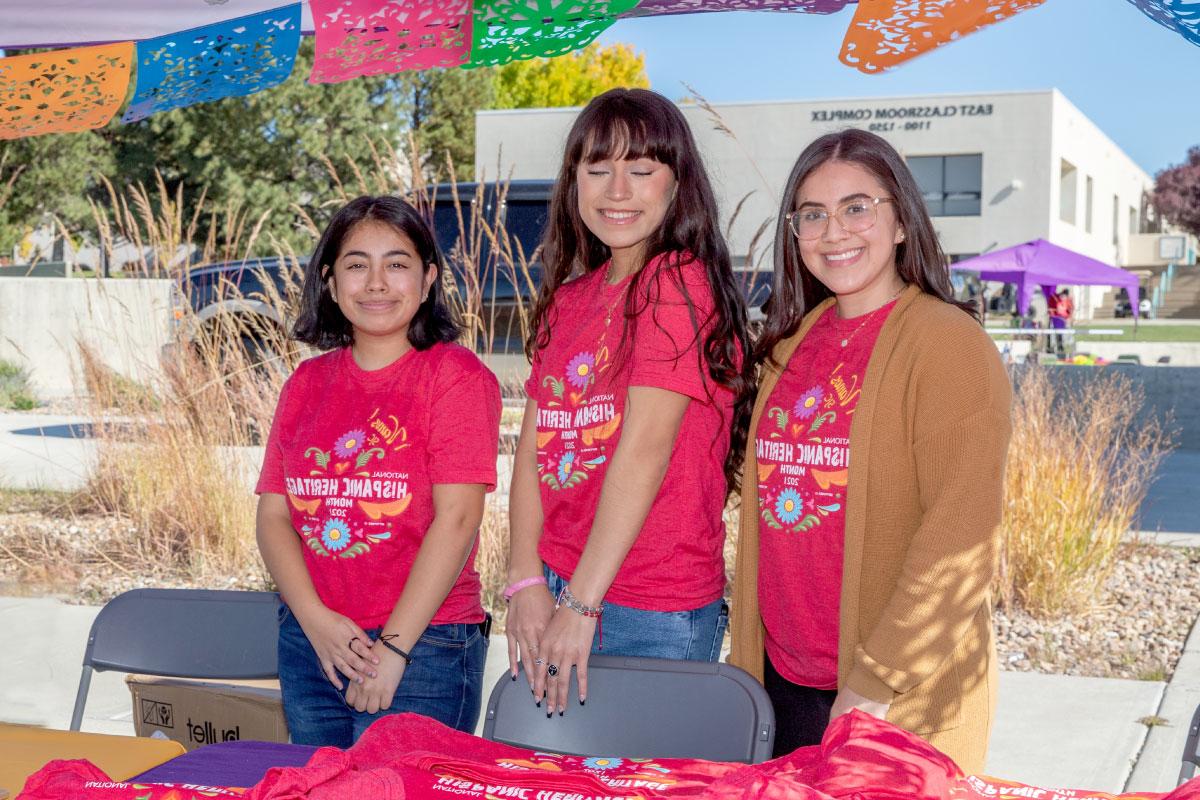 Three students wearing red shirts